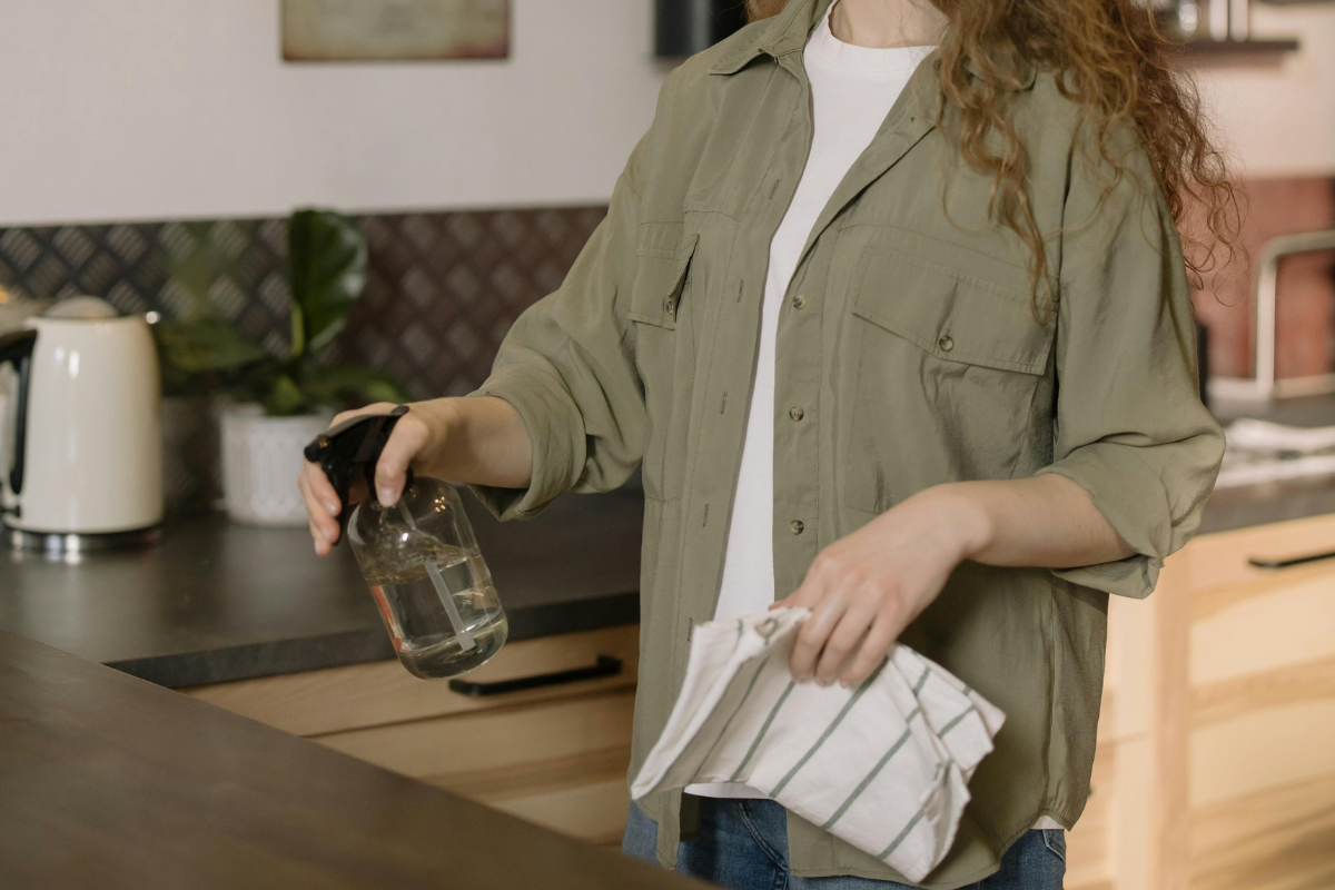 Woman cleaning kitchen counter